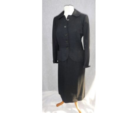 A USA 1940'S CHARCOAL GREY TWO PIECE SUIT, UK modern size 10,the jacket with button front and fitted waistline and a pencil s