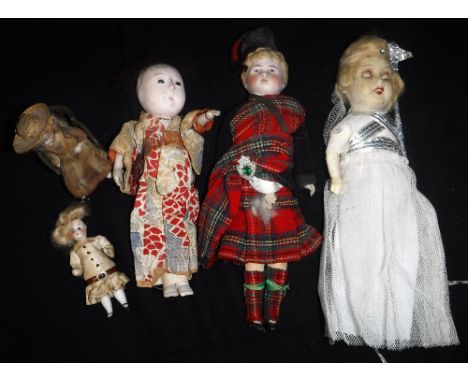 A VINTAGE CHRISTMAS FAIRY circa 1930s,  a Scottish boy with ceramic head, in traditional costume and similar dolls