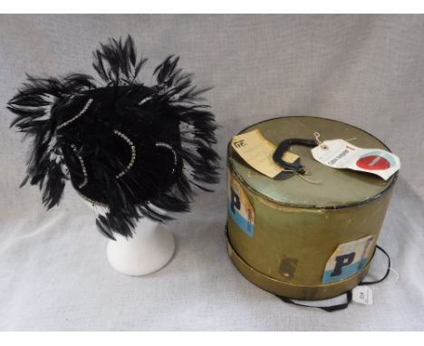 A VINTAGE BLACK 1920'S STYLE SKULL CAP, decorated throughout with diamante style braid and feathers, the interior label 'An O