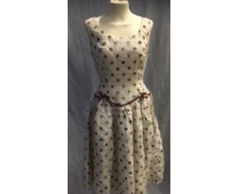 A CREAM AND LIGHT BROWN SPOTTED FLOCK NYLON PARTY DRESS, the waistline with brown satin trim, circa 1960