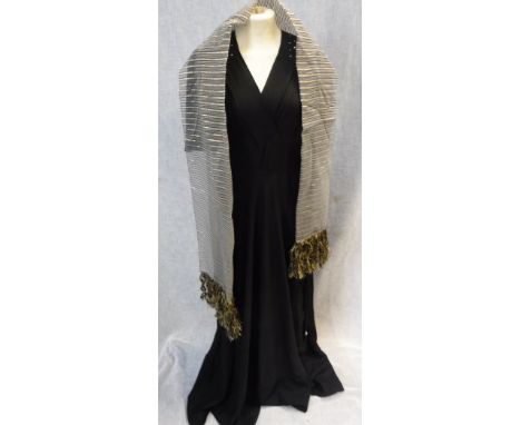 A FULL LENGTH BLACK CREPE EVENING DRESS, the shoulders and sleeves decorated with clear beadwork, circa 1940 and a modern gre