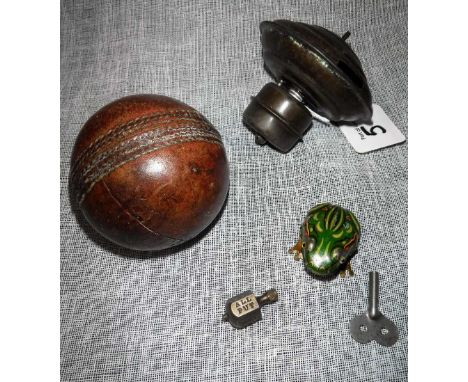 A SMALL TINPLATE CLOCKWORK FROG (with key) a tinplate top, a brass spinner and a Vintage leather cricket ball