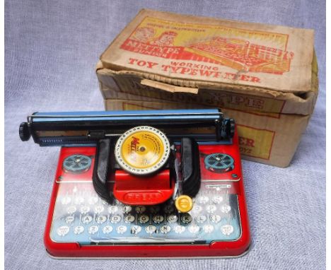 A VINTAGE TIN PLATE 'METTYPE' JUNIOR WORKING TOY TYPEWRITER with original box