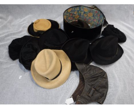 A VINTAGE LEATHER CYCLING OR FLYING HELMET and a collection of vintage hats contained in a hatbox 