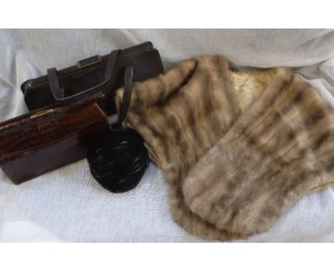 A LIGHT BROWN FUR STOLE, a feather skull cap and two skin bags