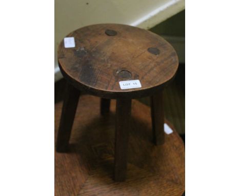 A FOUR LEGGED MILKING STOOL 