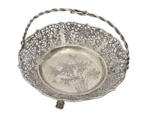 A Chinese pierced silver basket, early 20th c, with entwined handle, engraved with bird and insect amidst bamboo, on three ba