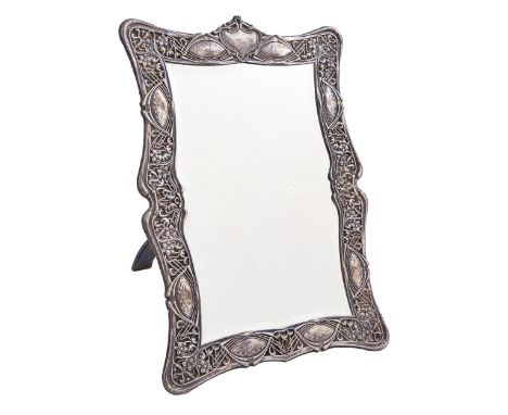 An Edward VII Art Nouveau silver dressing mirror, the openwork mount die stamped with stylised flowers and whiplash stems, 51