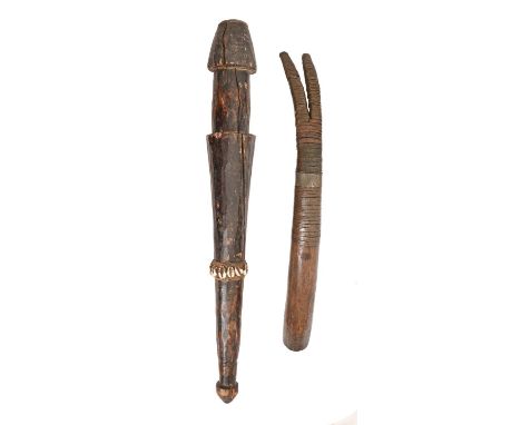 Tribal art. Central Africa - a carved wood club, decorated with a band of cowry shells, 62cm l and a hardwood side blown trum