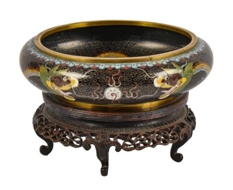 A Chinese cloisonne enamel bowl, 20th c, with ferocious dragons on a black ground, 20cm diam, four character seal mark, hardw