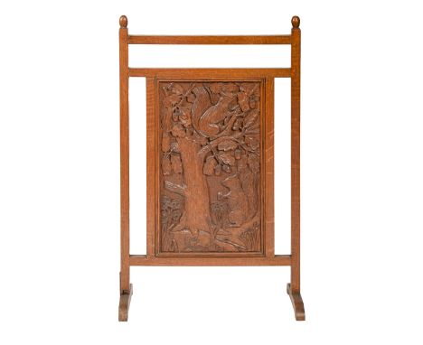 An oak firescreen incorporating a carved panel of two squirrels, mid 20th c, 48.5cm l  Good condition