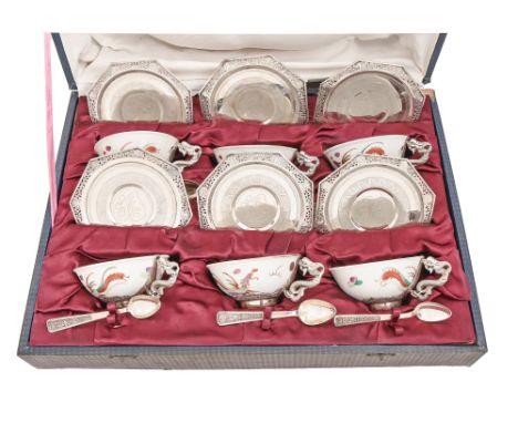 A set of six Vietnamese silver mounted dragon handled porcelain teacups, pierced octagonal saucers and spoons, second quarter