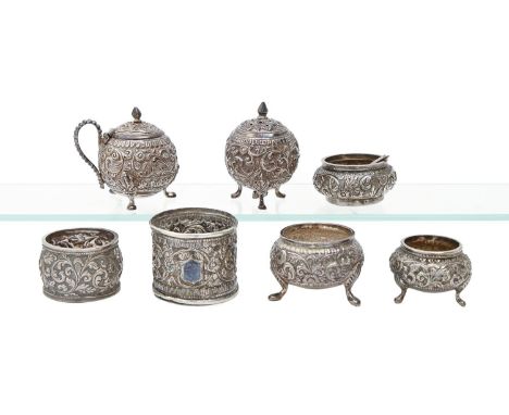 An Indian silver spherical repousse condiment set and similar salt cellar, Cutch, c1900, various sizes, maker's mark, another