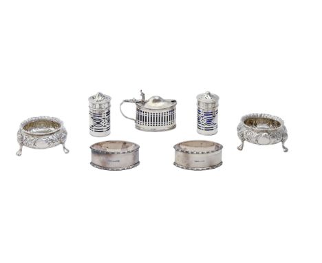 A pair of Victorian silver salt cellars, chased with flowers, 65mm diam, by Charles Stuart Harris, London 1877, a pierced sil