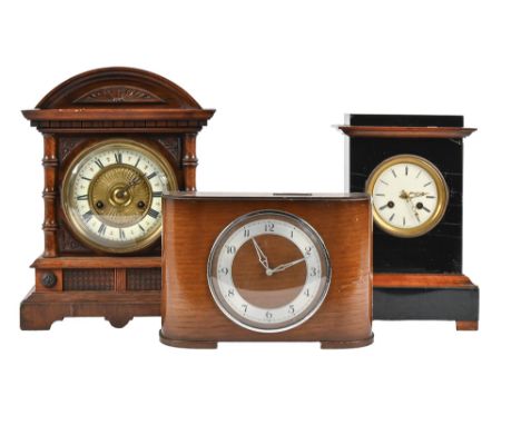 An English oak coin-in-the-slot mantel clock, c1940, with black plastic slot in the top 2 FLORINS WEEKLY, 19cm h and two Cont