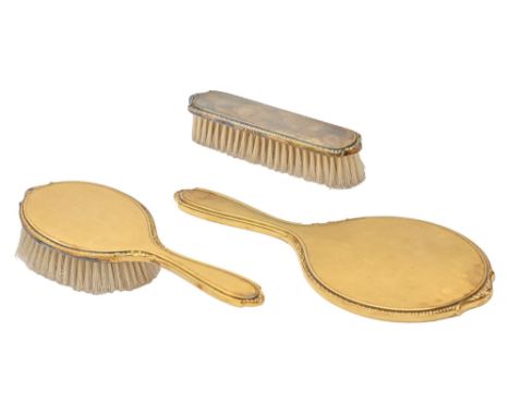 An Elizabeth II silver gilt brush set, engine turned, by Adie Brothers Ltd, Birmingham 1961, cased (4)  As new, comb lacking 