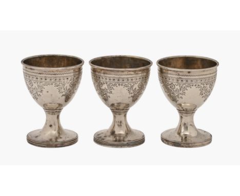 A set of three George III bright cut silver eggcups, engraved with flowers, 68mm h, by Stephen Adams, London 1814, 4ozs 15dwt