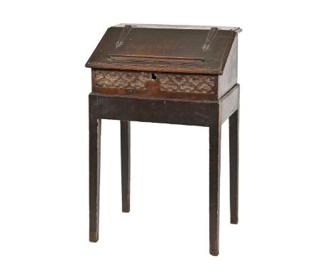 A George II oak bureau on stand, the shaped iron hinges to the lid original, the lid indistinctly stamped with initials R B, 