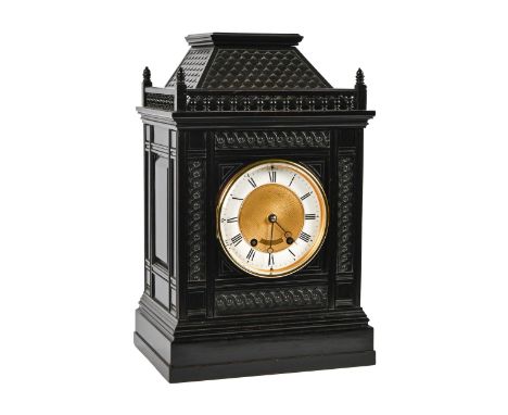 A German architectural ebonised bracket clock, late 19th c, with enamel chapter ring and turned gallery around 'tiled' pedime