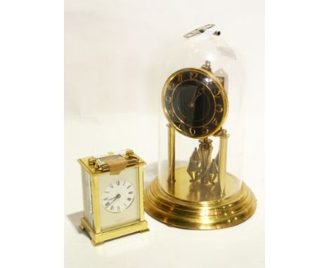 A brass anniversary clock under glass dome and a Shortland Bowen brass commemorative carriage clock for the marriage of Princ