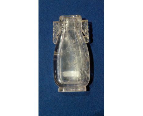 Chinese rock crystal vase, flattened baluster shape with pierced scroll handles, engraved with landscape, dog finial on carve
