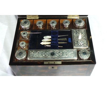 A Victorian coromandel brass-mounted travelling vanity case having comprehensively fitted interior, lift-out tray, fitted jar