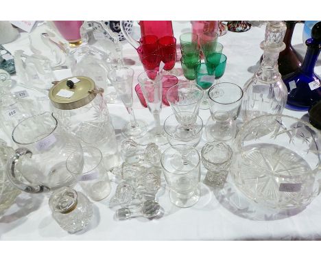 A quantity of cut glass including a large fruit bowl, two decanters, a cut glass biscuit barrel with metal cover, various 'ru