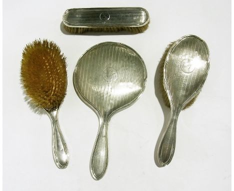 Early 20th century silver dressing table set comprising pair brushes, clothes brush and hand mirror, engine-turned, engraved 