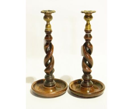 Two wooden turned candlesticks with brass candlestick holders and a framed tapestry 