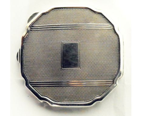 A lady's silver compact with engine-turned design, Birmingham 1979, 3oz approx.  