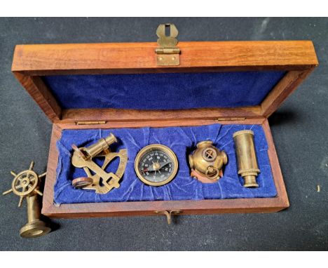 CASED SET OF MINIATURE BRASS NAUTICAL INSTUMENTS/ITEMScomprising a sextant, a three draw telescope, a diver's helmet with cop