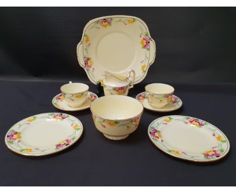 CROWN STAFFORDSHIRE TEA SETdecorated with a yellow ground with a floral border and gilt highlights, comprising twelve cups an