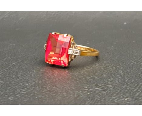 RED GEM AND DIAMOND SET RINGthe central checkerboard cut gemstone possibly ruby and measuring 10mm x 8mm x 5mm, flanked by sm