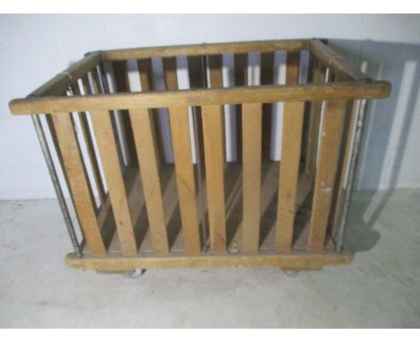 A slatted wooden industrial bobbin trolley