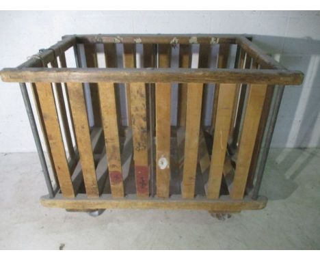 A slatted wooden industrial bobbin trolley