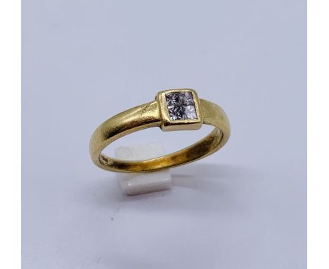 An 18ct gold ring set with four small diamonds