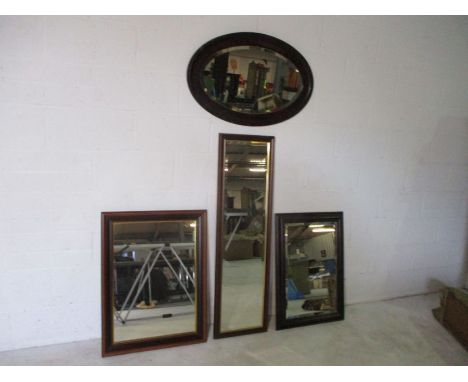 An Edwardian over mantle mirror plus three modern dark wood mirrors