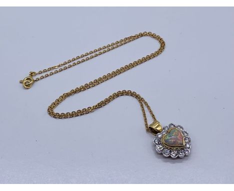 An opal and diamond heart shaped pendant set in 18ct gold on a fine 18ct gold chain