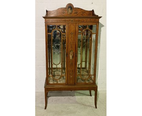 An Edwardian satinwood display cabinet with painted scrolling decoration including portrait of the Duchess of Devonshire. One