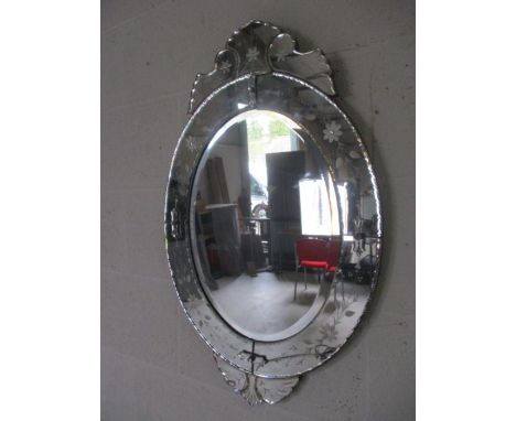 A Victorian style ornate oval mirror.