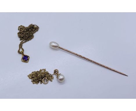 Two 9ct gold pendants on fine chains along with an unmarked gold stick pin, total weight 5.4g