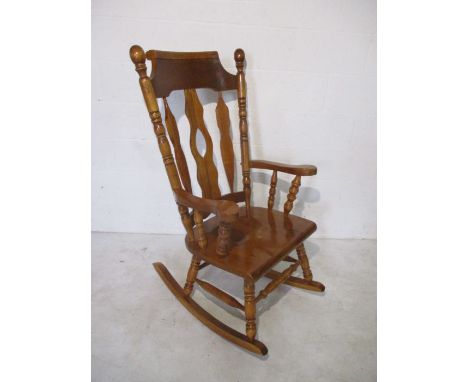 A large rocking chair with turned supports  