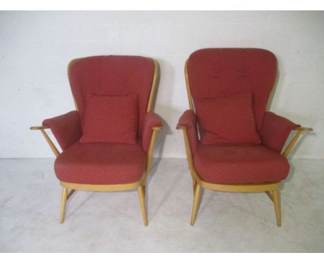 A pair of Ercol Evergreen stick back arm chairs with a pair of matching cushions.