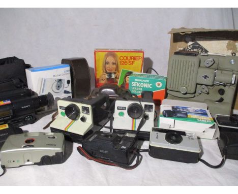 A collection of cameras, a projector and a Sony Handy Cam Video 8. Includes two Polaroid land cameras, a Kodak Instamatic, a 