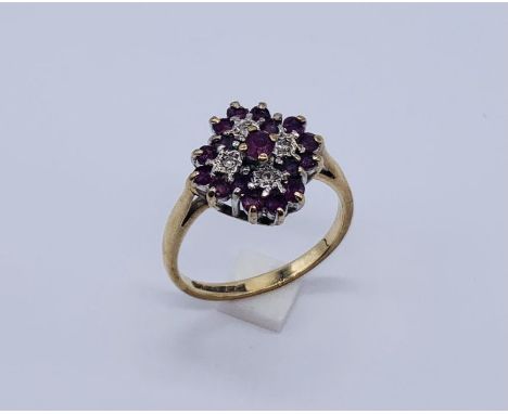 A ruby and diamond cluster ring set in 9ct gold 