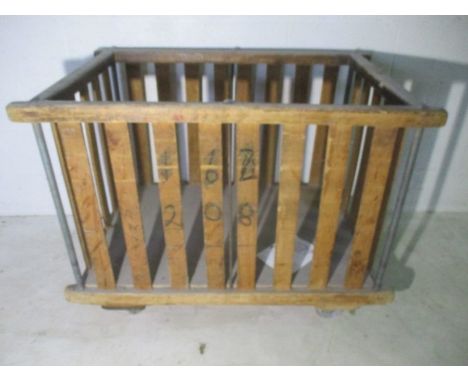 A slatted wooden industrial bobbin trolley