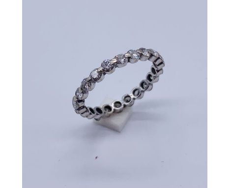 A tested 18ct white gold eternity ring set with diamonds