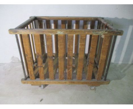 A slatted wooden industrial bobbin trolley