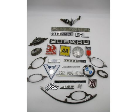 A collection of various car badges including BMW, Triumph, AA, Vauxhall, Saab 99, Subaru, Ford etc