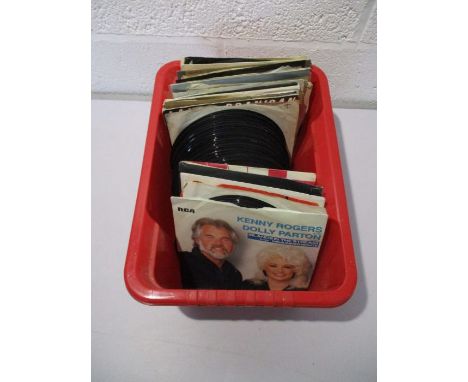 A collection of 7" vinyl singles including Elvis Presley, Rolling Stones, Queen, Roy Orbison, Tom Jones, Stevie Wonder, Wings